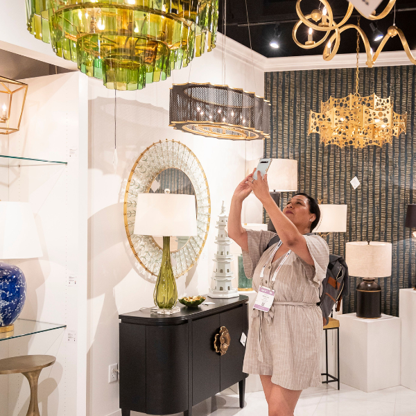 Woman Snapping Photo of lamp in Showroom at Las Vegas Market